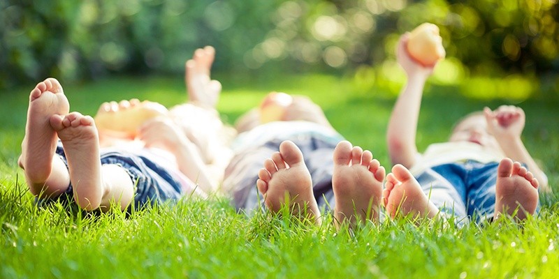 children laying on grass