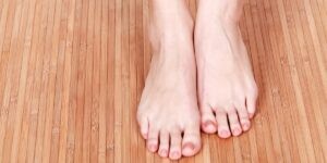 Two feet on wood surface for problems caused by diabetes. 
